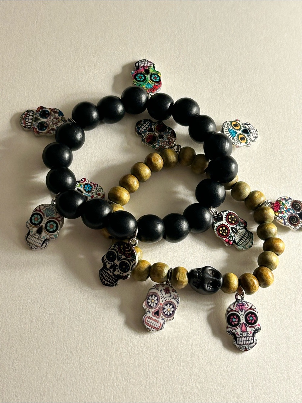 2 Charm Bracelets bright enamel skulls, black tan wood black skull beads stretch
